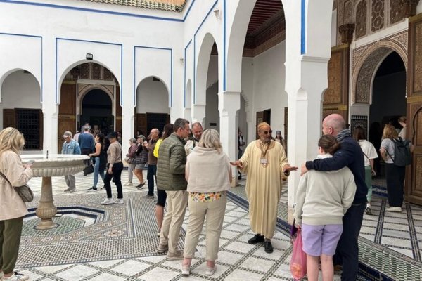 Travellers discovering a traditional riad courtyard in Marrakech